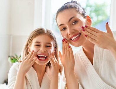 Mother and daughter caring for skin